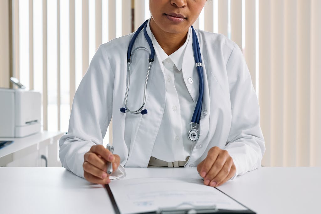 Man in White Suit With Blue Stethoscope